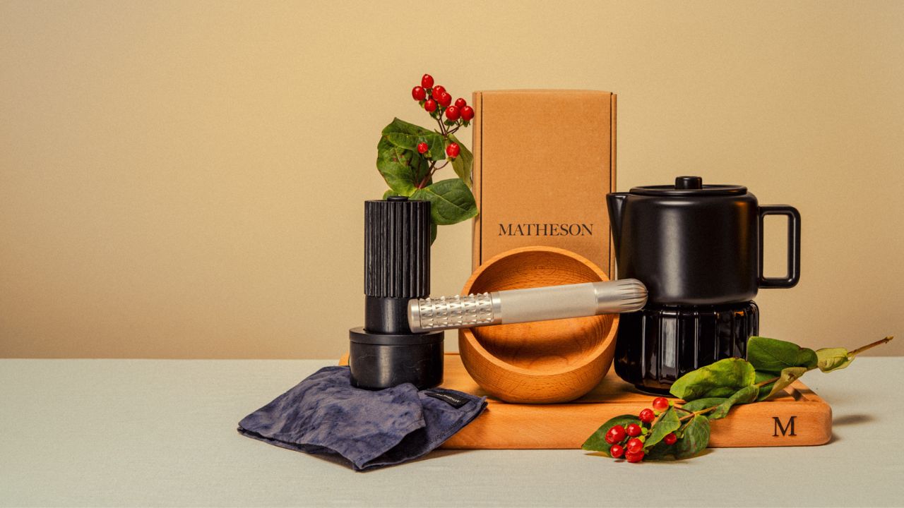 Collection of kitchen items including a coffee grinder, bowl, and mug on a beige background with Matheson branding.